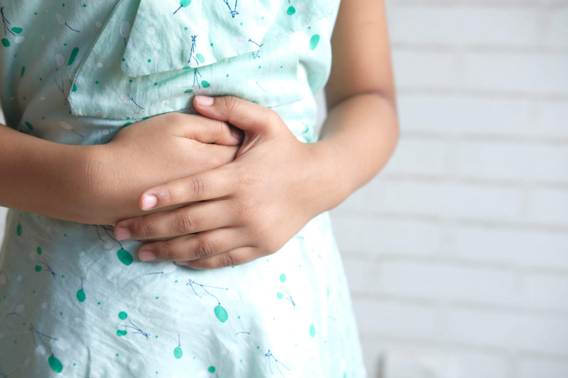 girl suffering stomach pain close up.