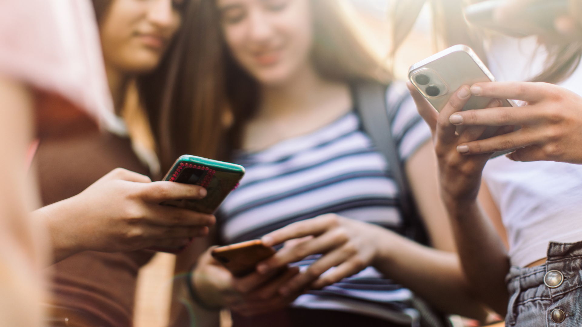 a group of teen girls each with a smartphone in their hands
