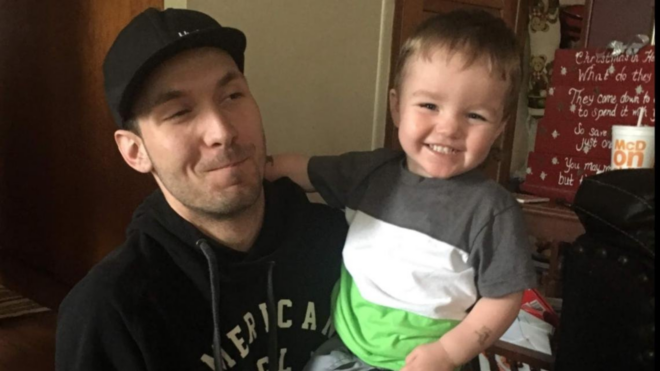 Dustin Manis holding missing son Hayden Manis