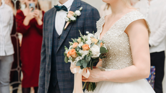 bride and groom walking down the aisle with guests in the background