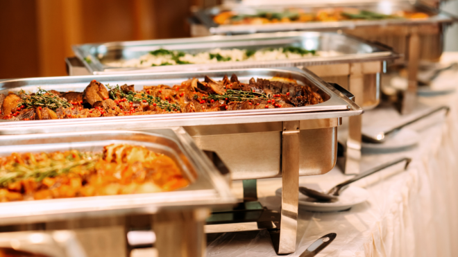 a table full of individual trays of food at a wedding or big event