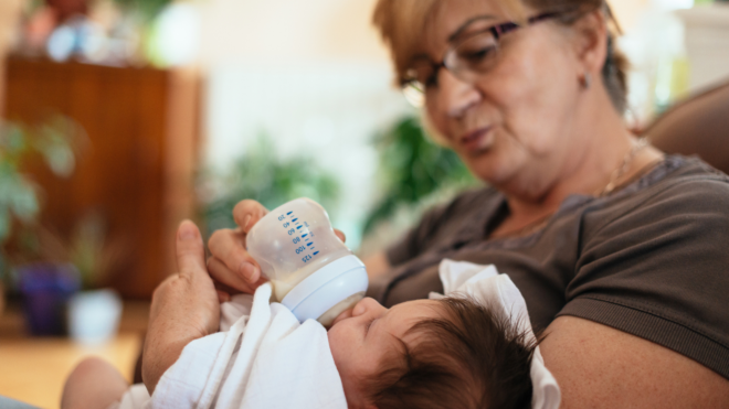 grandma feeding baby a bottle