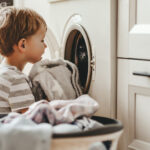 Toddler doing laundry