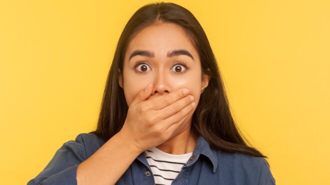 Girl covering her mouth in shock