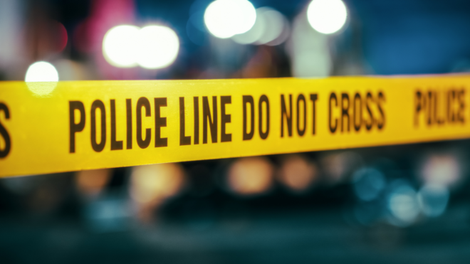 yellow police tape in front of distorted lights