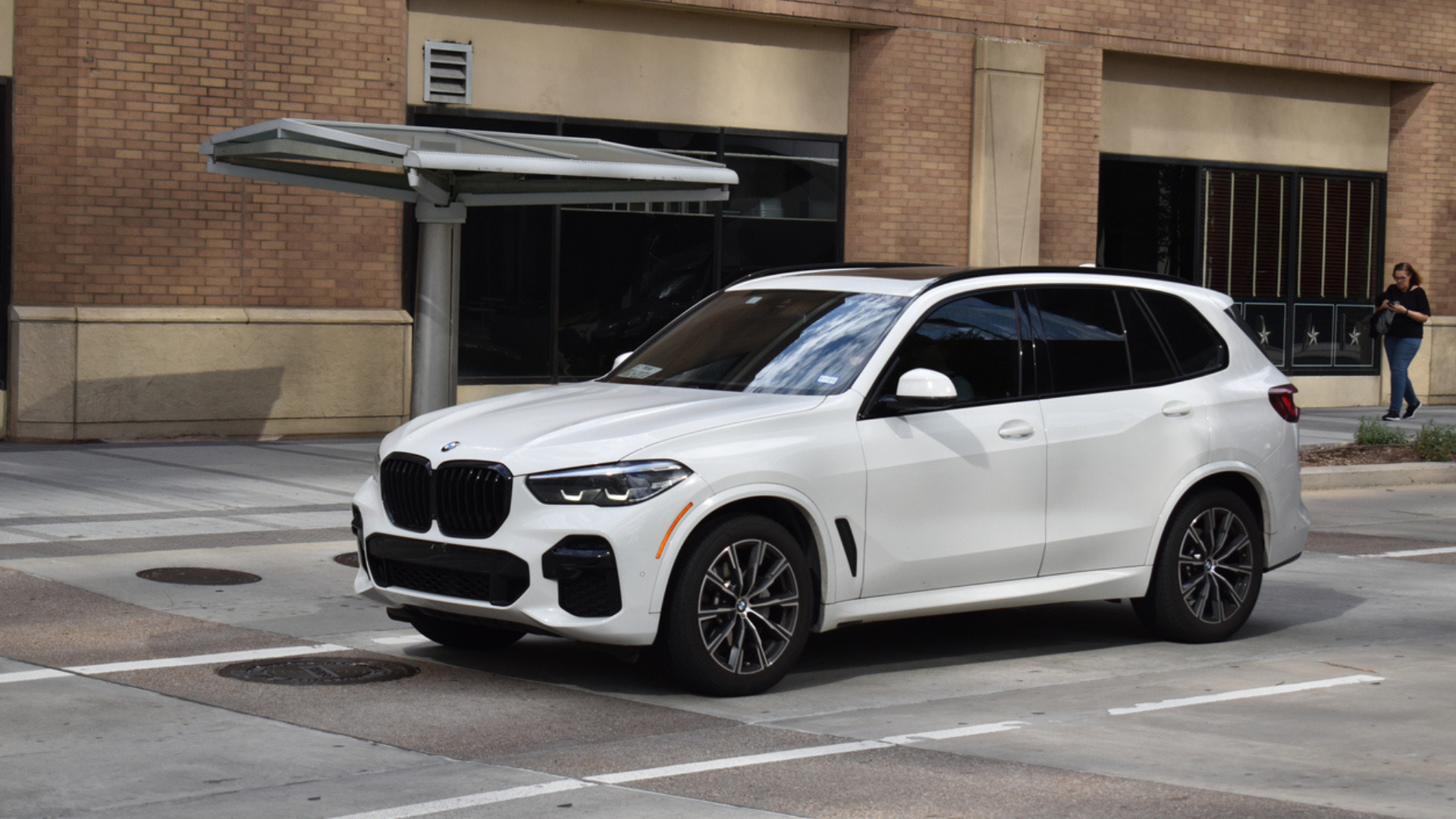 white SUV driving down city street