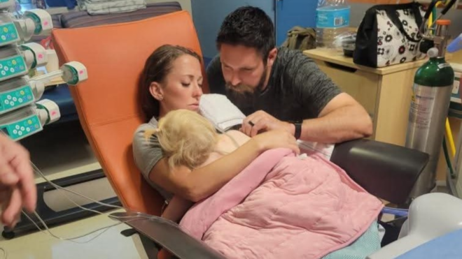 Jacquelyn and Matthew Reed holding daughter Cara Reed