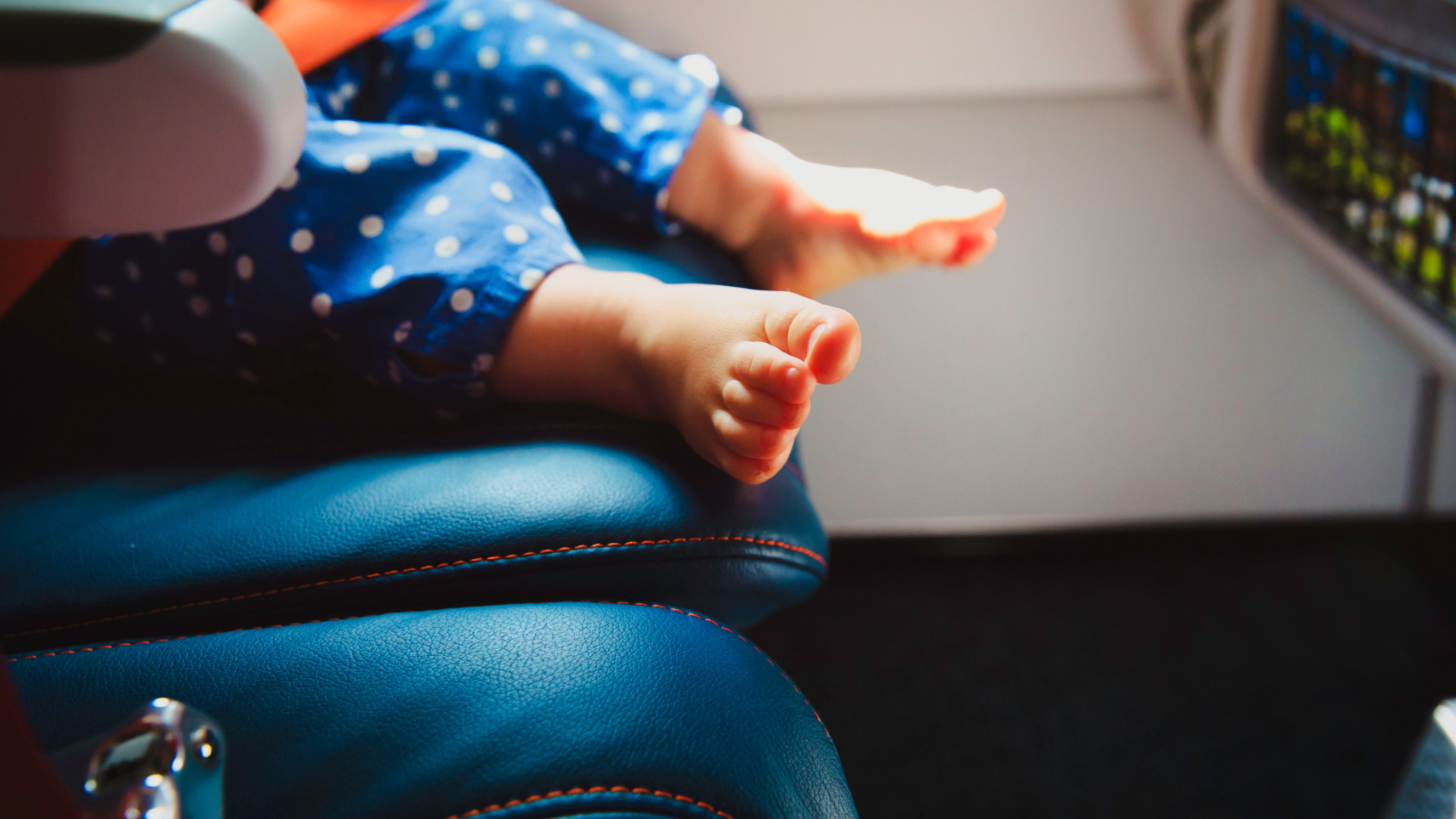baby feet sitting in airplane seat