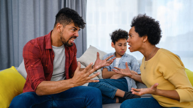 Black couple arguing while their son sits in the background