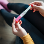 woman holding pregnancy test