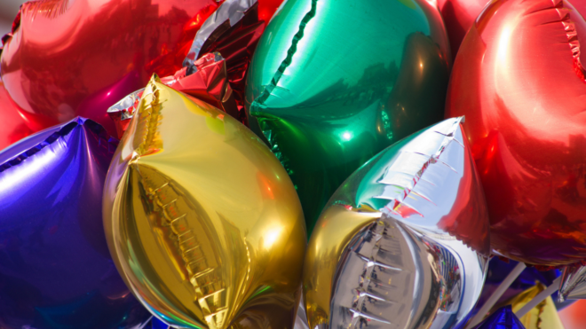 a cluster of brightly colored Mylar balloons