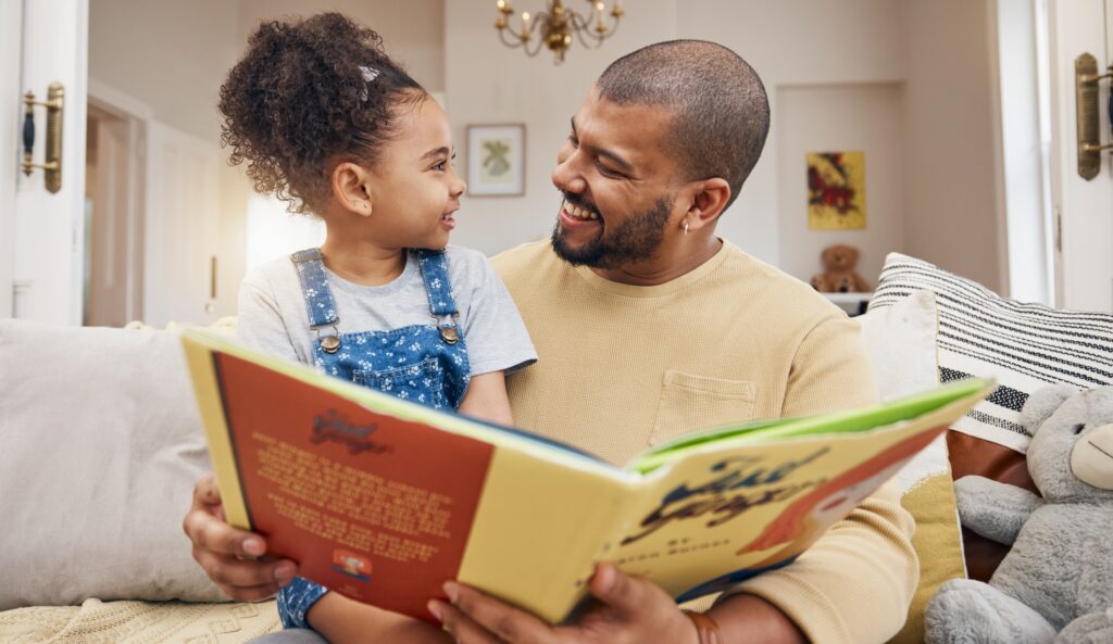 Father reading to daughter