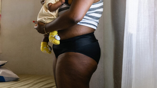 Mother in panties holding baby