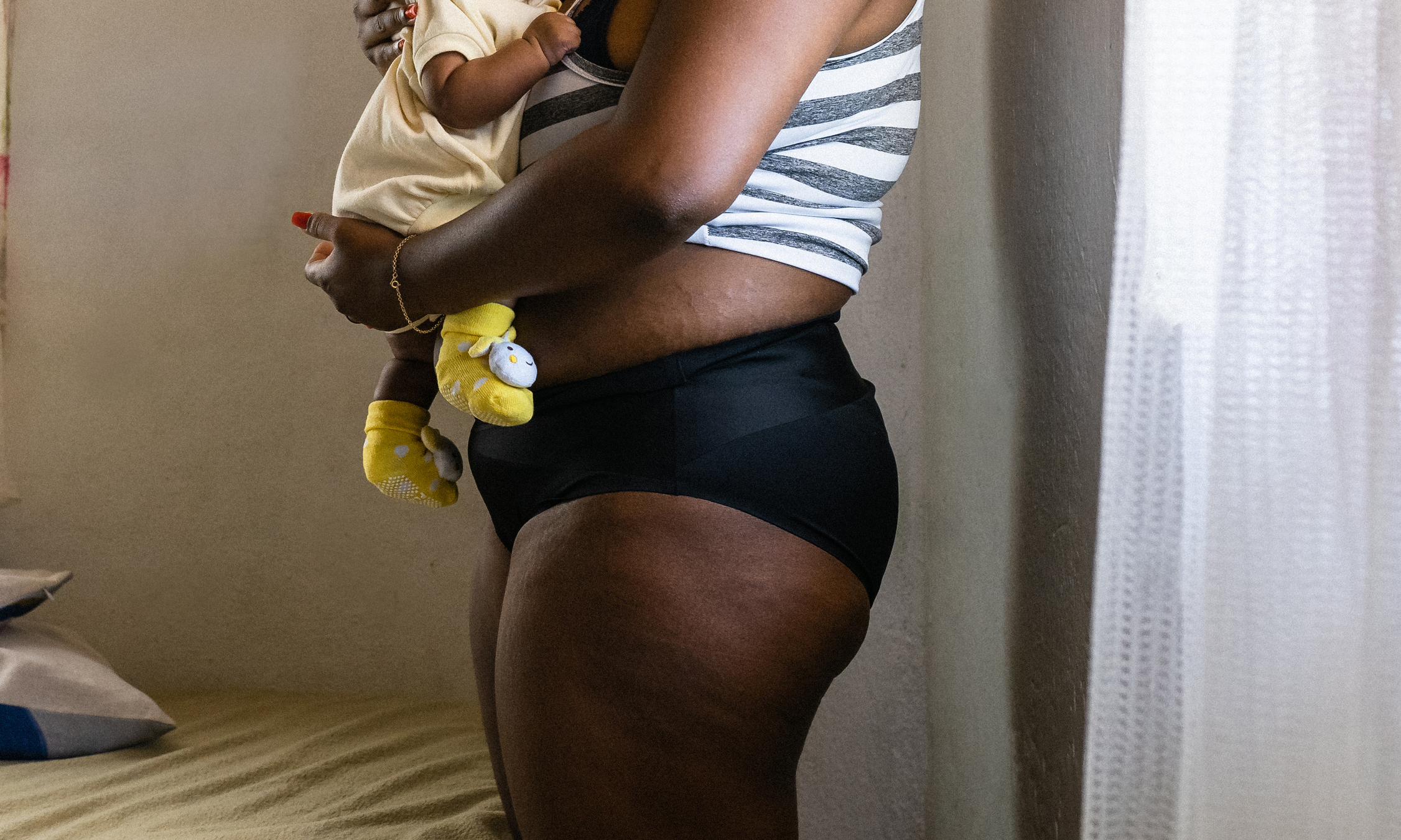 Mother in panties holding baby