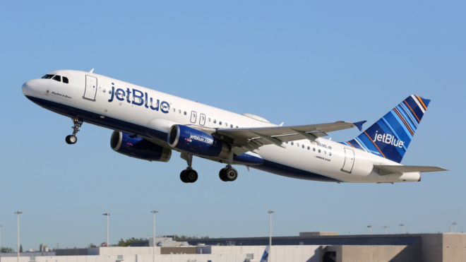 white JetBlue airplane taking off