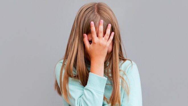 girl putting head in heads frustrated.