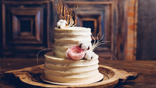 rustic wedding cake on wooden cake plate