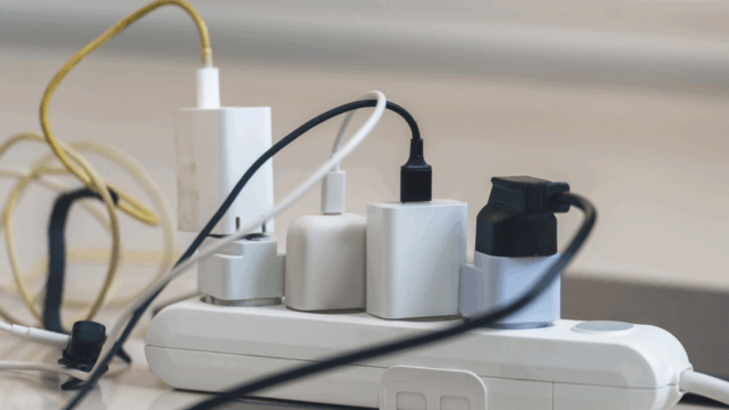 electric power strip filled with different electronic chargers