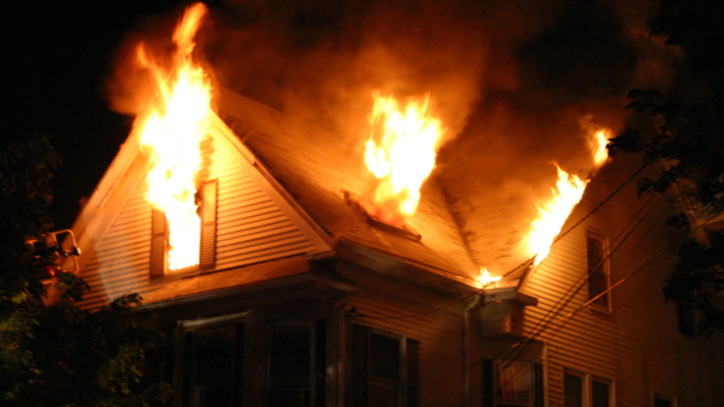 house at night with flames out of the windows