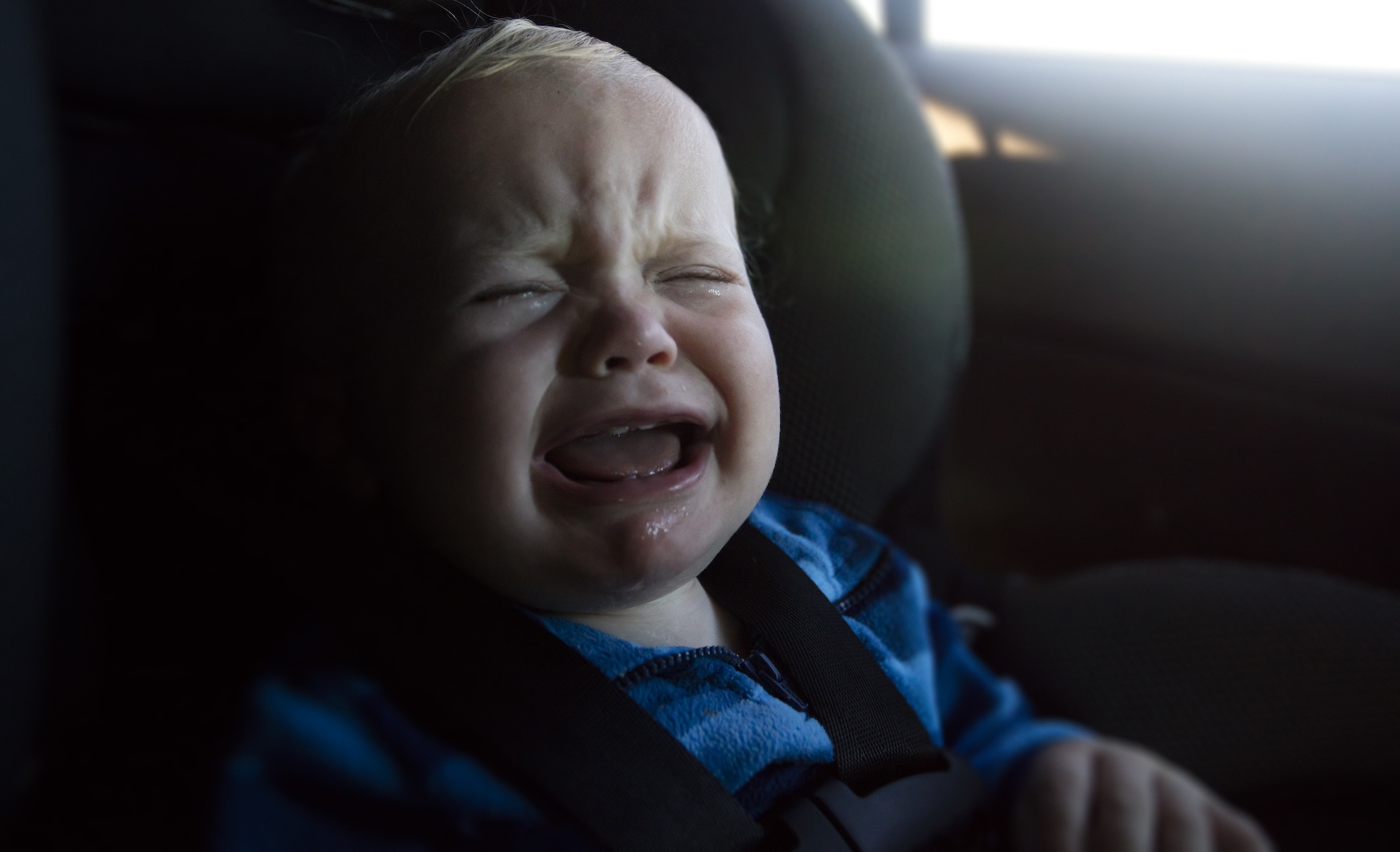 Baby boy crying in car seat