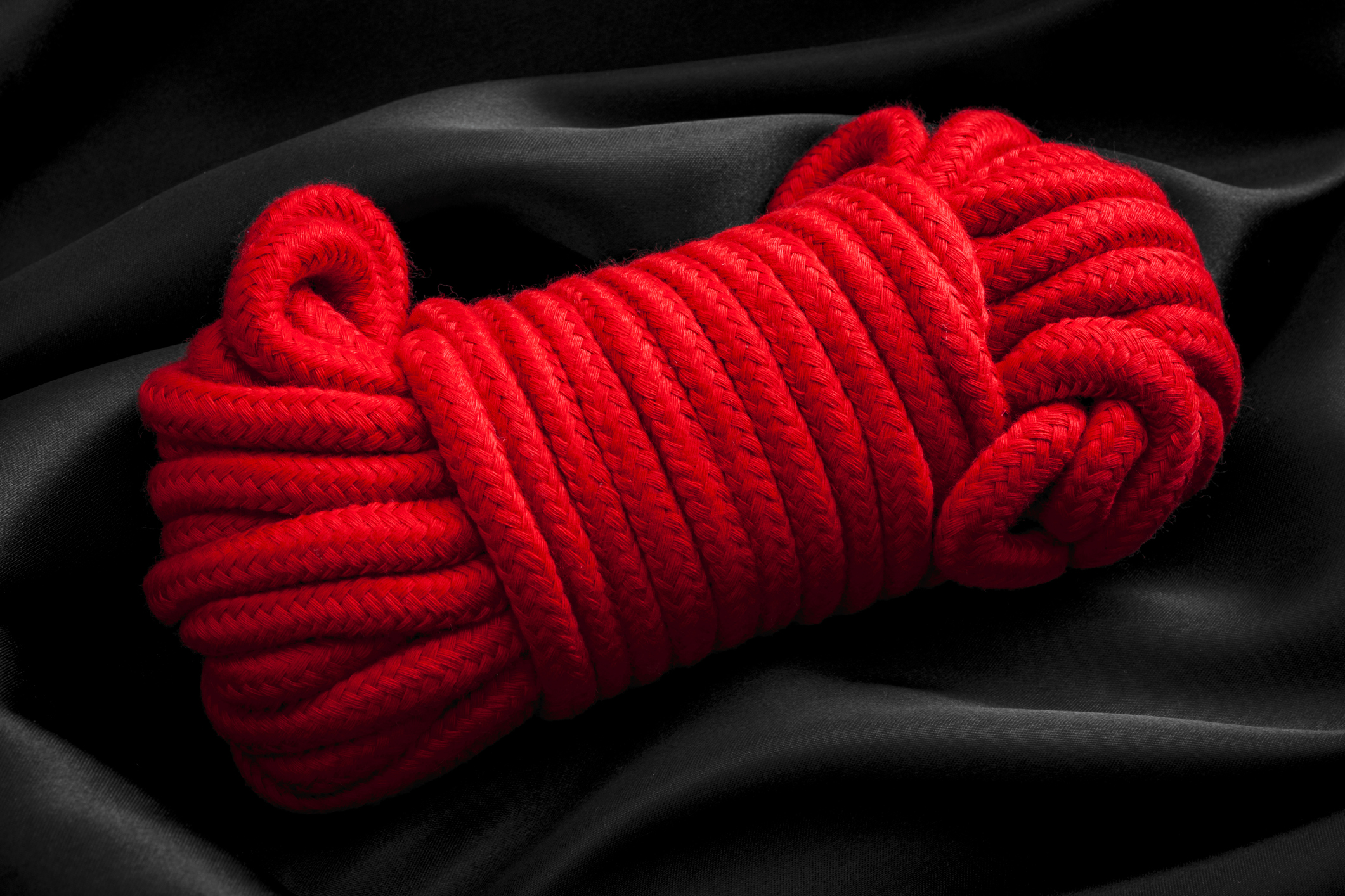 Ball of red rope used in bdsm games and kink Ball of red rope used in bdsm games and kink