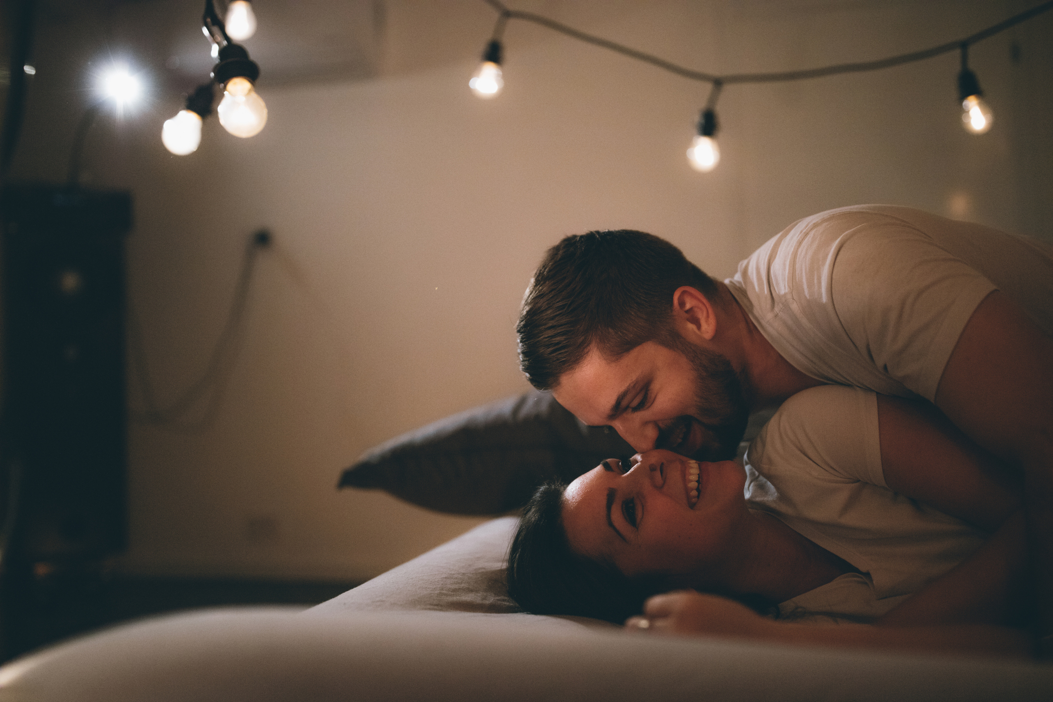 couple in bed with lights