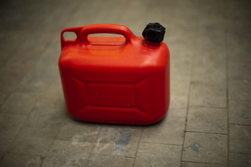 Red canister of fuel. Oil tank.