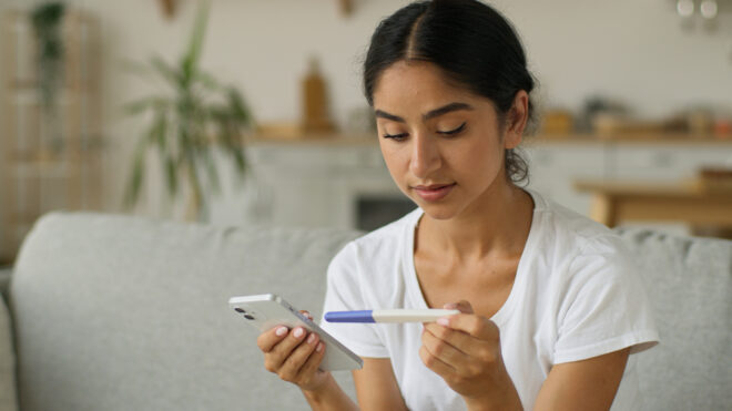 Woman looking at pregnancy test