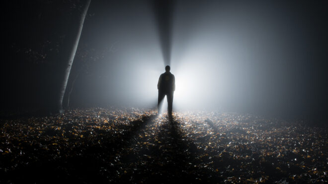 Silhouette of a tall man in the forest