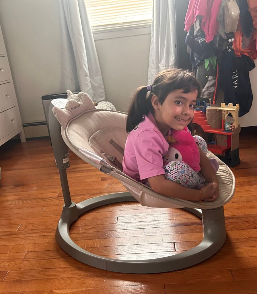 toddler in momcozy swing used as chair