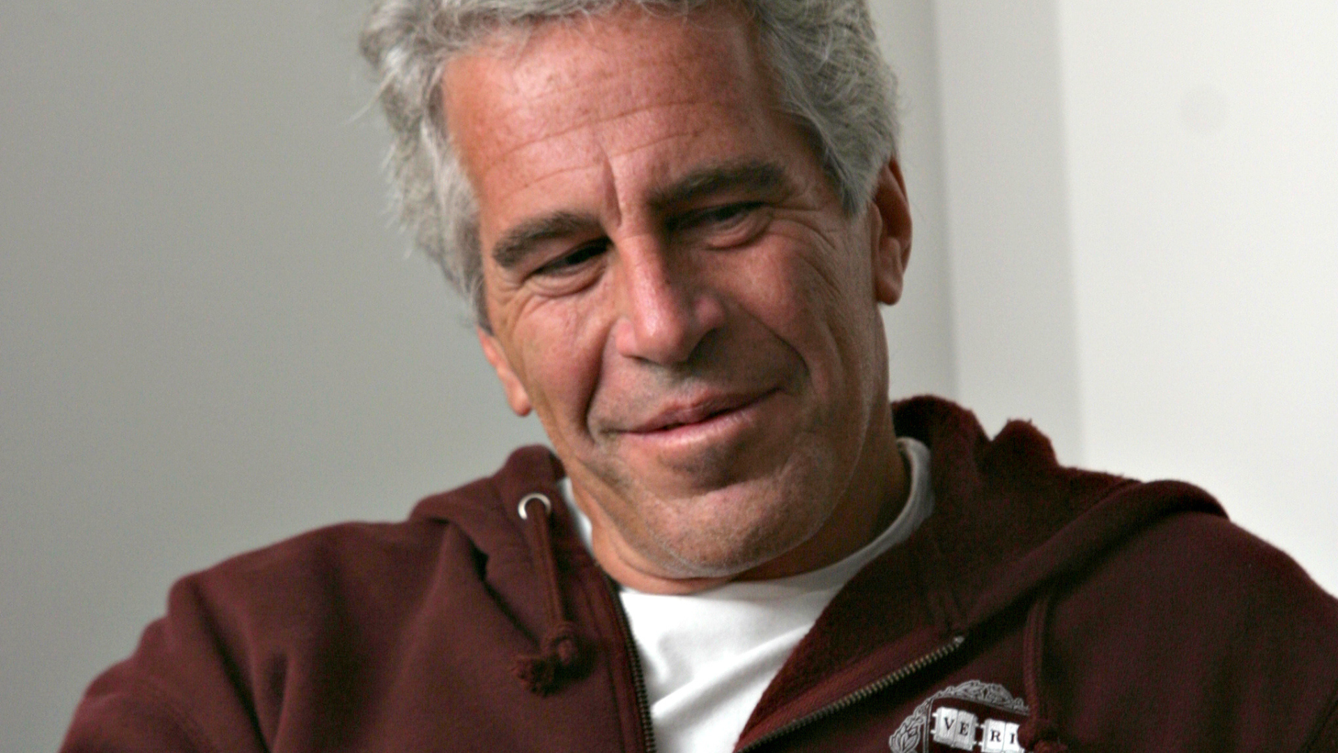 jeffery epstein in maroon-colored sweater