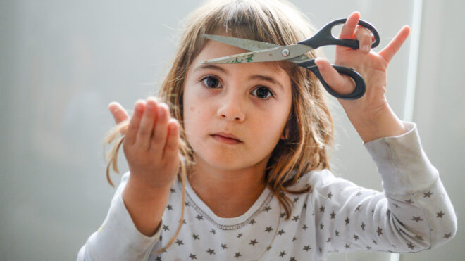 a little girl cuts her own hair