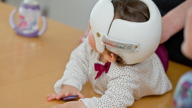 baby girl in a helmet