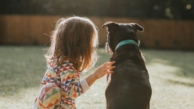 a little girl with a dog