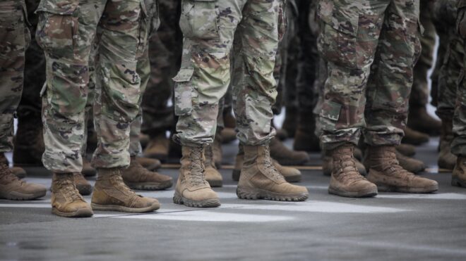 u.s. army men in a line in full uniform, visible rom the legs down