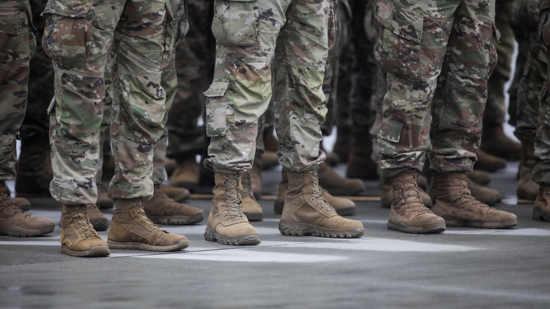 u.s. army men in a line in full uniform, visible rom the legs down