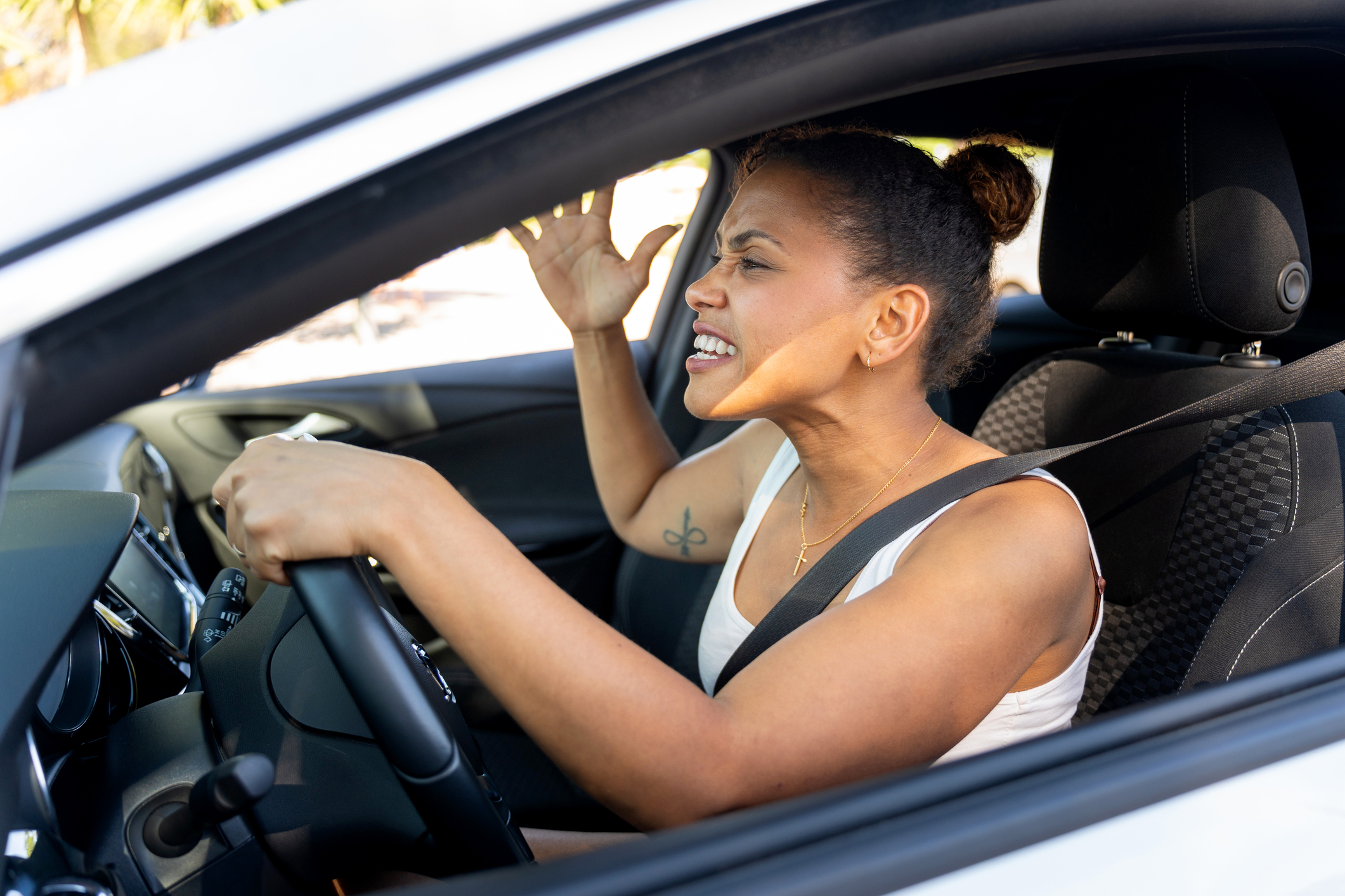 Latin tourist getting angry while driving rental car during road trip, experiencing road breakdown and getting stressed