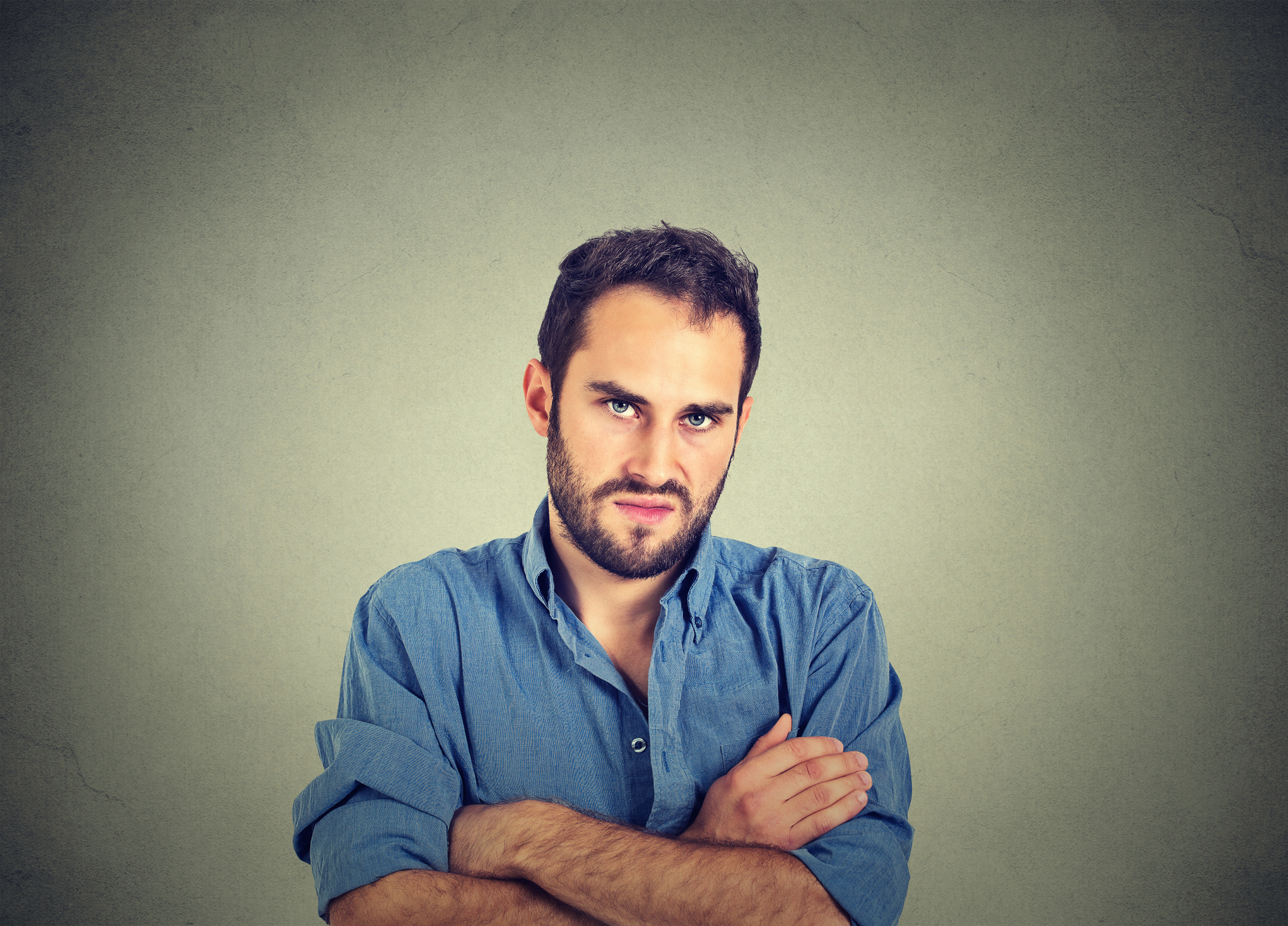 Closeup portrait of angry young man, about to have nervous breakdown, isolated on gray wall background. Negative human emotions facial expression feelings attitude