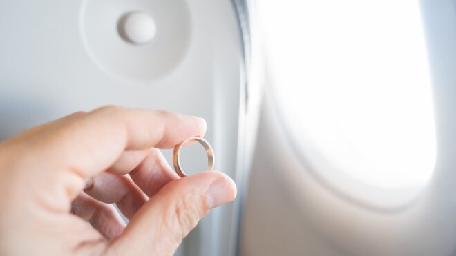 Wedding band in front of plane window