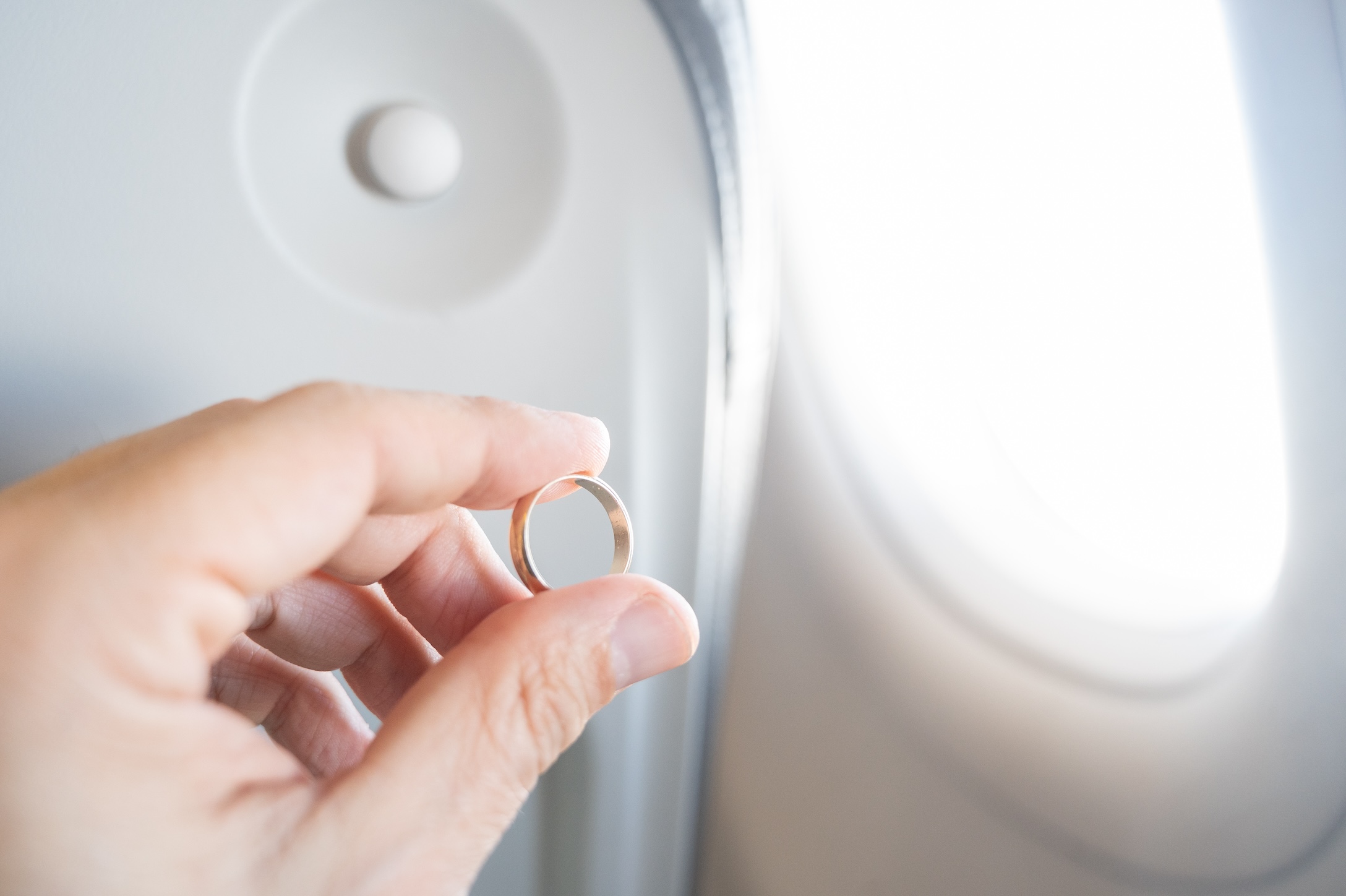 Wedding band in front of plane window