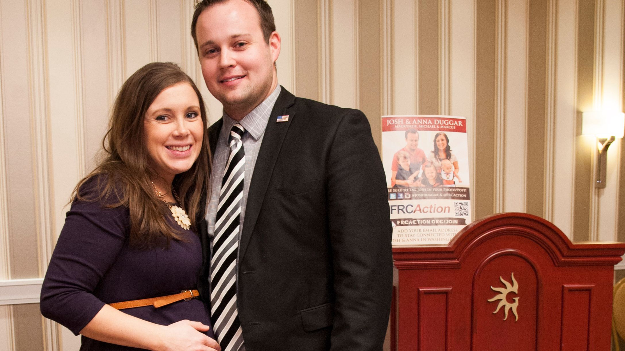 Anna and Josh Duggar posing together at an event