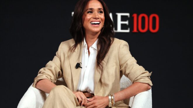 Meghan Markle sitting down for an interview in a beige linen suit at the Time 100 Summit in 2025