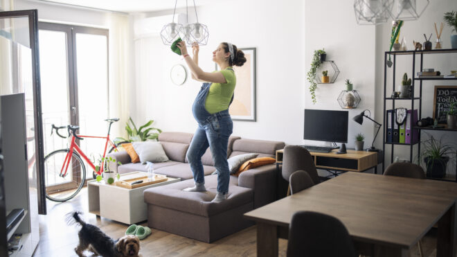 Expecting woman cleaning up before baby arrival.