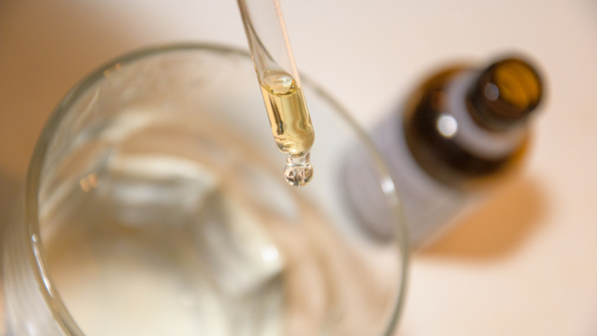 liquid medication dropped into water glass