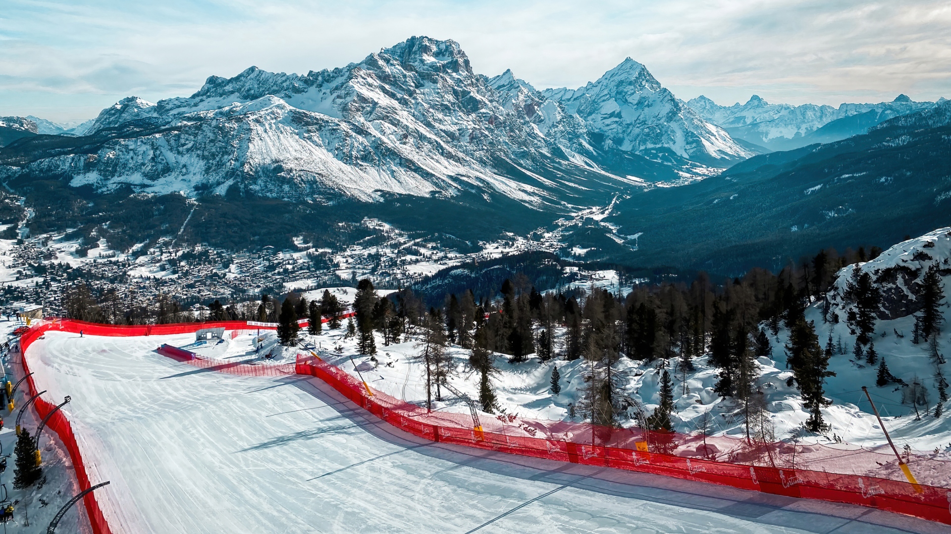 Scenic view of Tofana ski racing slope in Cortina d'Ampezzo in Italy against snow covered Punta Sorapiss Mountain (middle) and Antelao (right)