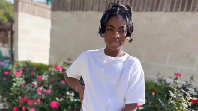 riley standing in front of flowers