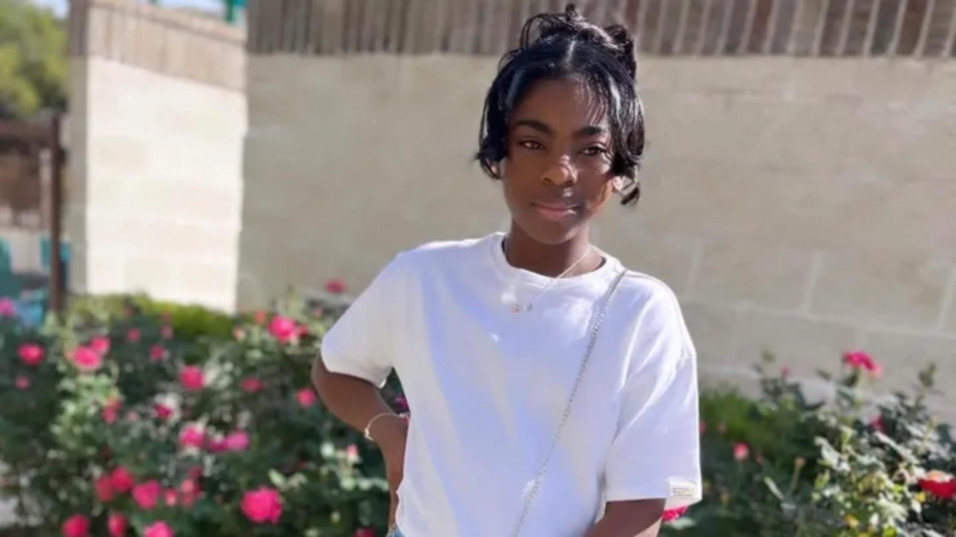 riley standing in front of flowers