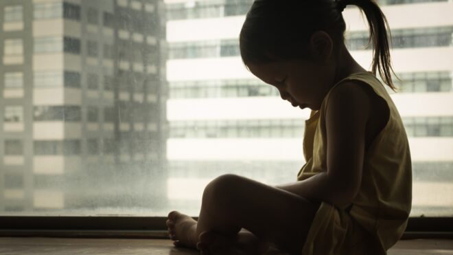 girl alone by window
