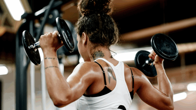 woman at the gym lifting weights