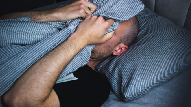 Photo showing young adult male with sleep problems